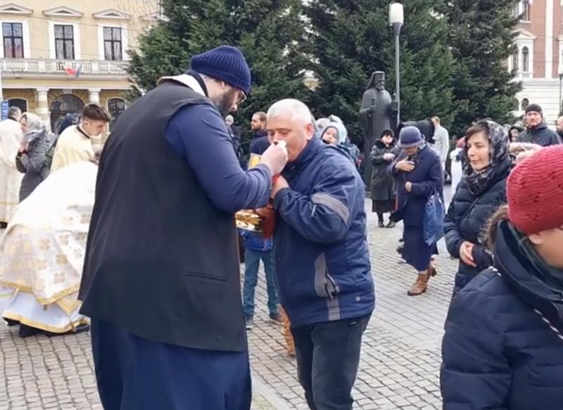 Credinciosi care se impartasesc la Cluj Napoca, in fata catedralei, Foto: Captura de ecran