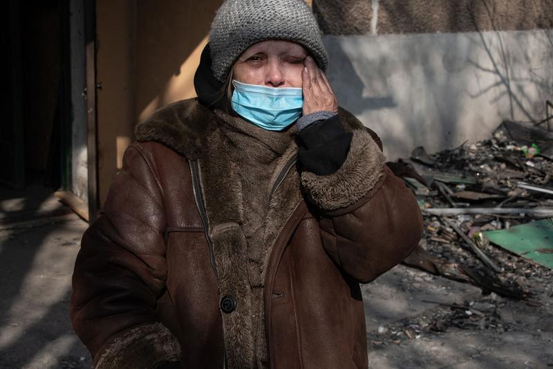 Femeie din Mariupol isi sterge lacirmile in fata ruinelor casei ei, Foto: Maximilian Clarke/SOPA Images/Profimedia Images