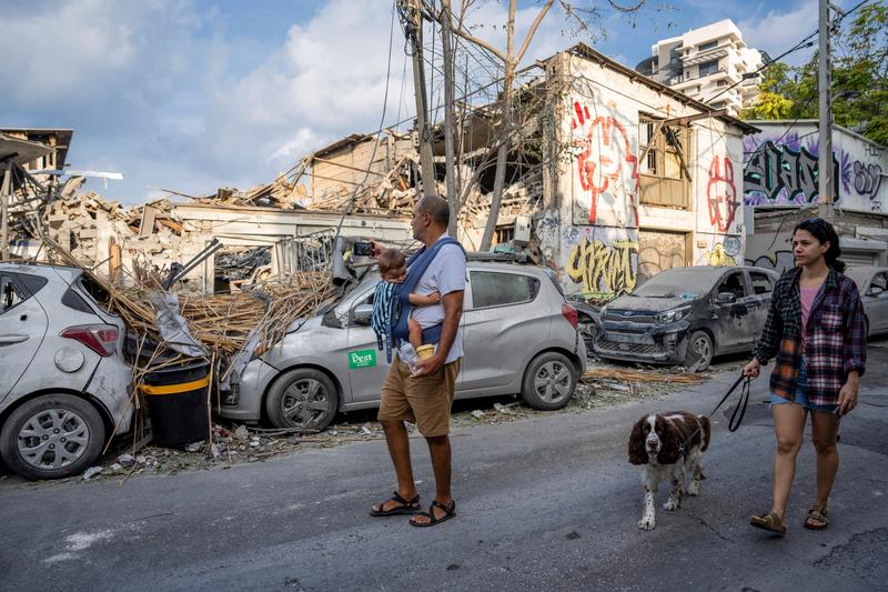 Israelieni lângă o clădire din Tel Aviv distrusă de lovituri Hamas, Foto: Oded Balilty / AP / Profimedia