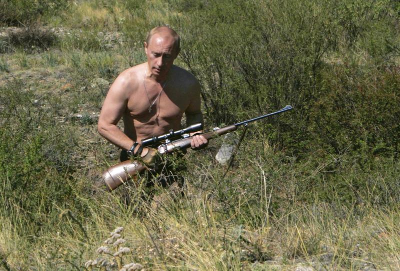 Vladimir Putin, în 2010, cu o armă de vânătoare și cu bustul gol, în regiunea rusă Tuva, la granița cu Mongolia, Foto: Dmitry Astakhov / AP / Profimedia
