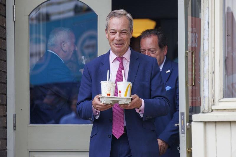 Nigel Farage, cu o tavă cu 4 milkshake-uri de banane. Mai devreme, o femeie i-a aruncat în față un milkshake de banane, Clacton on Sea, Marea Britanie, 4 iunie 2024., Foto: Mark Thomas / Shutterstock Editorial / Profimedia Images