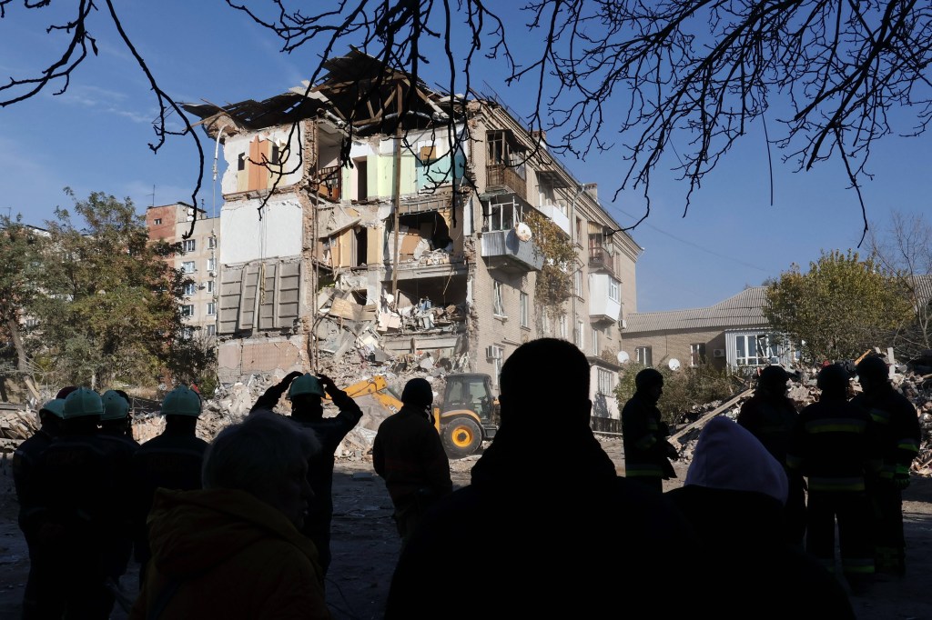 localnici și angajați ai serviciilor de urgență în fața unui bloc distrus de un atac rusesc în Zaporojie / FOTO: SOPA Images / Sipa Press / Profimedia