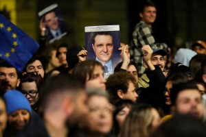 Susținători ai lui Nicușor Dan se adună în fața sediului de campanie din Blvd. Elisabeta din București, după închiderea urnelor la turul II al alegerilor prezidențiale, 18 mai 2025. Foto: Vadim Ghirda / AP / Profimedia